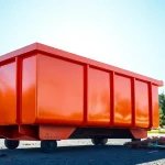 Engaging view of dumpster rental service Edmonton AB, showcasing a bright orange dumpster ready for use.