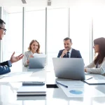Engaging consultant presenting contracts and grants in a modern office environment.
