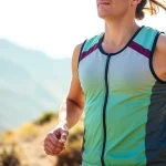 Runner demonstrating a stylish running vest while sprinting along a scenic trail.