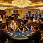 Players strategizing at the RR88 blackjack table under elegant chandeliers, showcasing an immersive casino experience.